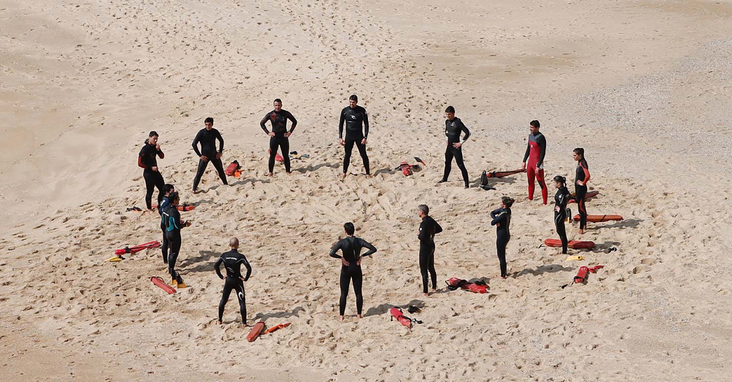 Group of people in a circle on the beach