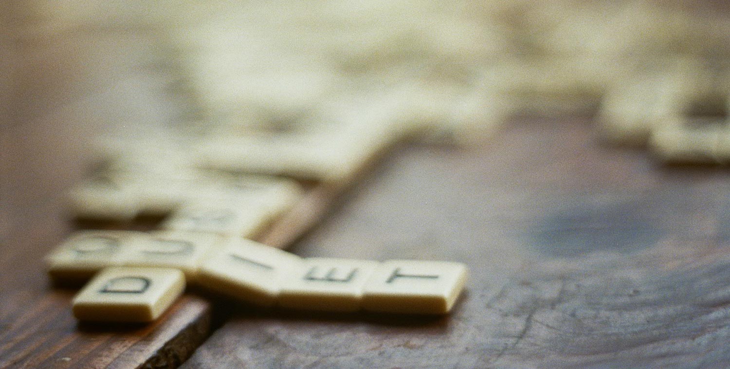 Blurred image of Scrabble tiles on a table
