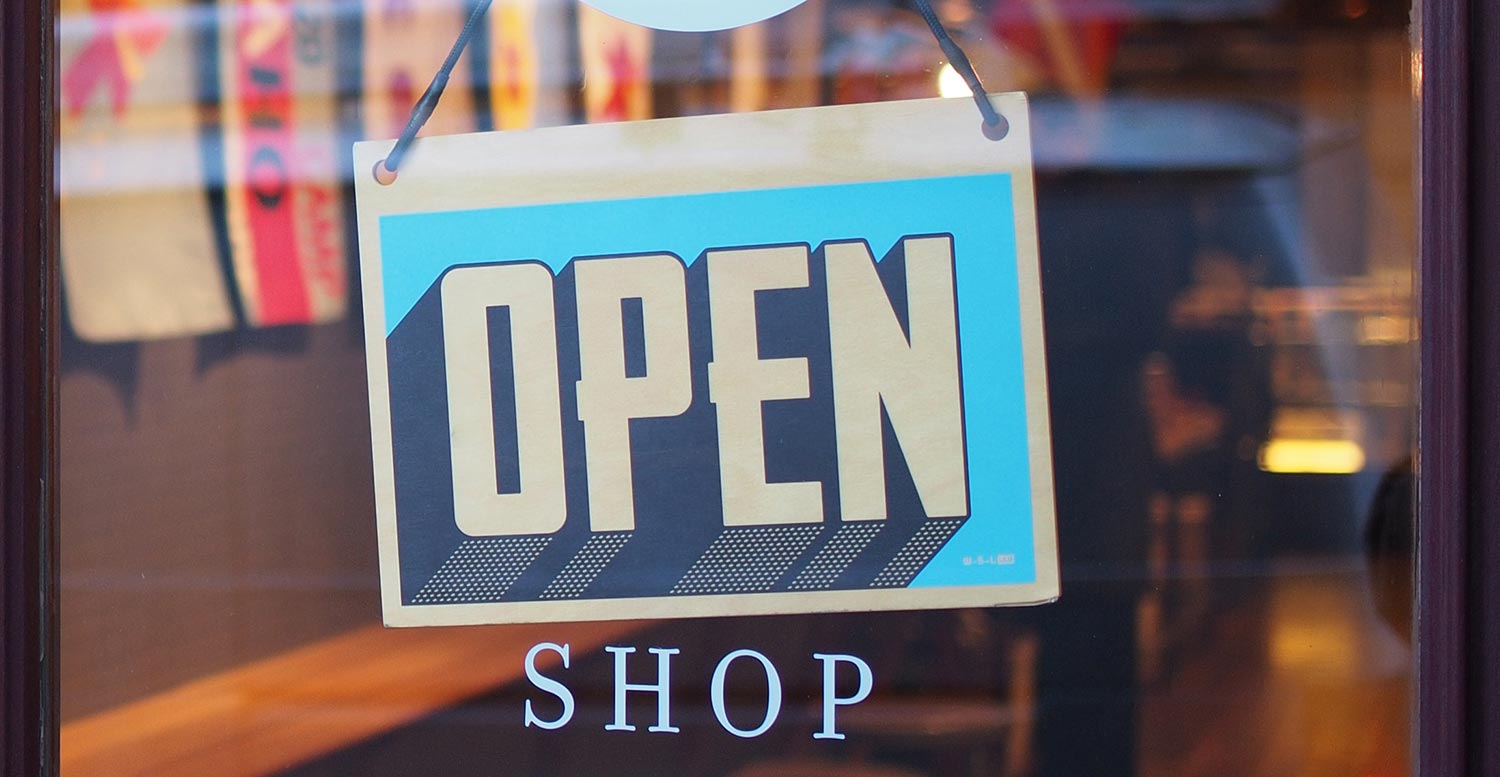 Blue shop sign saying "OPEN"