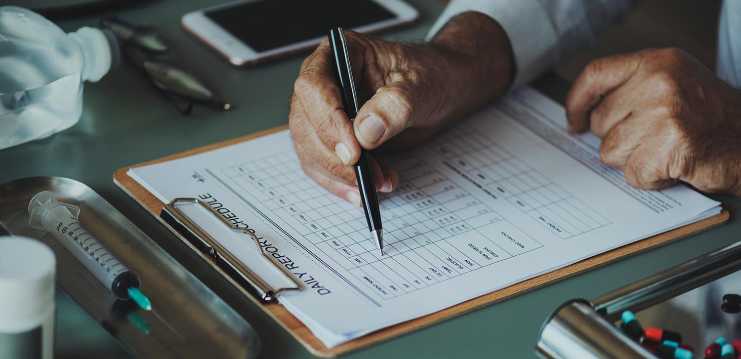 Hand writing on a clipboard