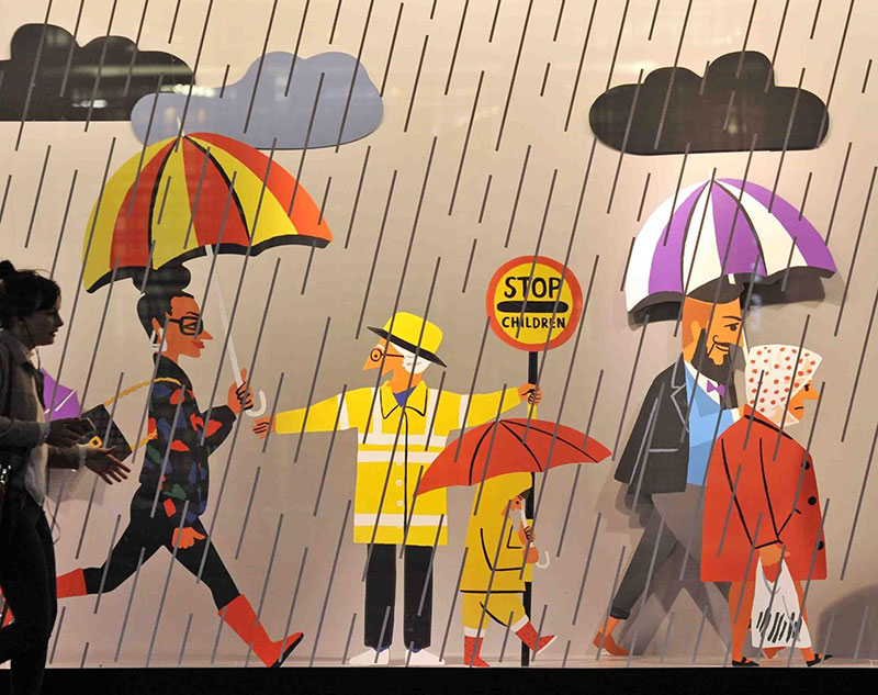 John Lewis National Holidays advert showing various people walking in rain in cartoon-form